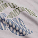 Showcasing an abstract design on fabric, the Canterbury Fundamentals T-shirt by Canterbury features two green and two blue curved shapes over a hexagonal mesh pattern, circularly arranged on a light background—making it ideal for athletic casual wear or as a bold accent on a rugby t-shirt.