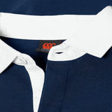 Close-up of the Canterbury Stripe Rugby Jersey by Canterbury, featuring a navy blue color, white collar and placket with visible buttons, and a black tag with red logo inside the collar. Classic rugby style inspired by traditional designs.