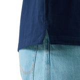 Close-up of the lower side of the Canterbury Stripe Rugby Jersey by Canterbury, featuring a side slit, styled over light blue denim jeans.