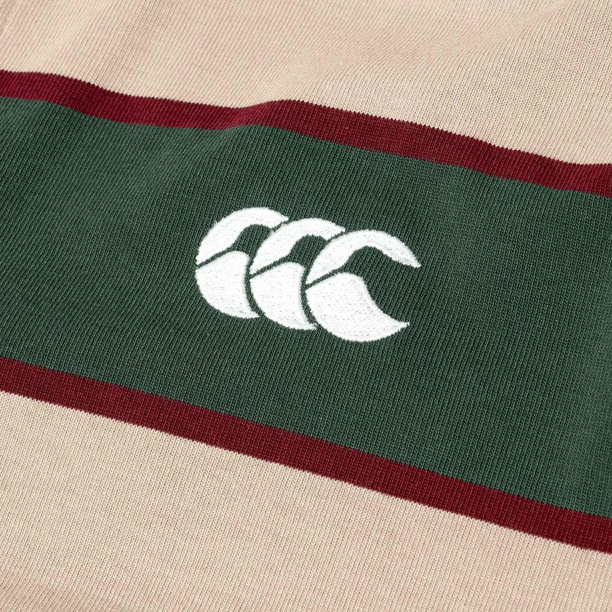 The Canterbury Stripe Rugby Jersey, in beige and green, features a white embroidered Canterbury rugby logo at the center.