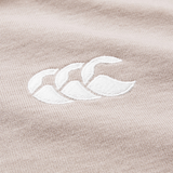 Close-up of beige fabric from the Canterbury Stripe Rugby, featuring a white embroidered logo with three overlapping curved shapes, inspired by the classic Canterbury design.
