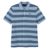 The Canterbury Yarn Stripe Polo by Canterbury is a short-sleeved rugby polo shirt featuring wide horizontal blue and light blue stripes, a traditional collar, and three white buttons on the placket, capturing the classic rugby style.
