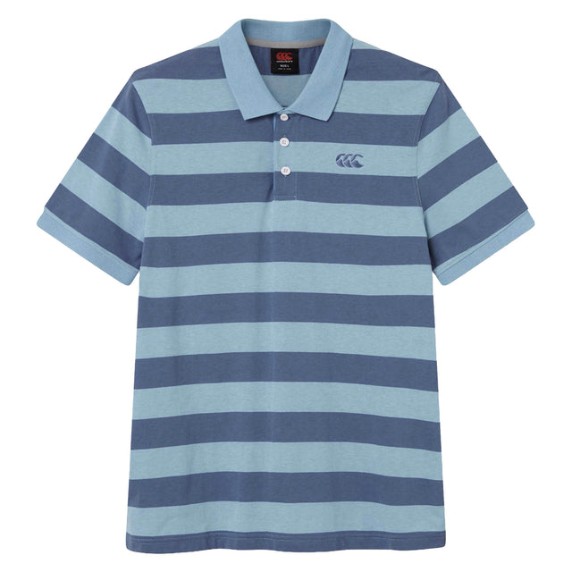The Canterbury Yarn Stripe Polo by Canterbury is a short-sleeved rugby polo shirt featuring wide horizontal blue and light blue stripes, a traditional collar, and three white buttons on the placket, capturing the classic rugby style.