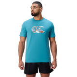 A man stands facing forward with arms at his sides, wearing a teal Canterbury Uglies Logo T-shirt in a soft cotton blend featuring a large logo on the chest, paired with black athletic shorts.