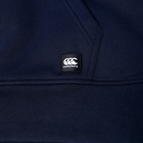 Close-up of a navy blue Canterbury Uglies Logo Hoodie, showcasing a visible pocket seam and a black Canterbury logo patch.