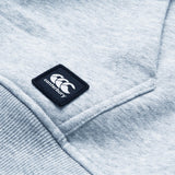 Close-up of a light gray Canterbury Uglies Logo Hoodie displaying a stitched Canterbury logo patch with three white overlapping C's on a black square background.