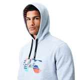 A man wearing the Canterbury Uglies Logo Hoodie in light gray, featuring a colorful Canterbury graphic on the chest and black drawstrings, looks at the camera against a white background.