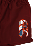 A close-up of Canterbury Uglies 5" Tactic Shorts in maroon, featuring an abstract geometric logo in white, orange, navy, and gray on the left leg—durable training shorts ideal for any athlete.