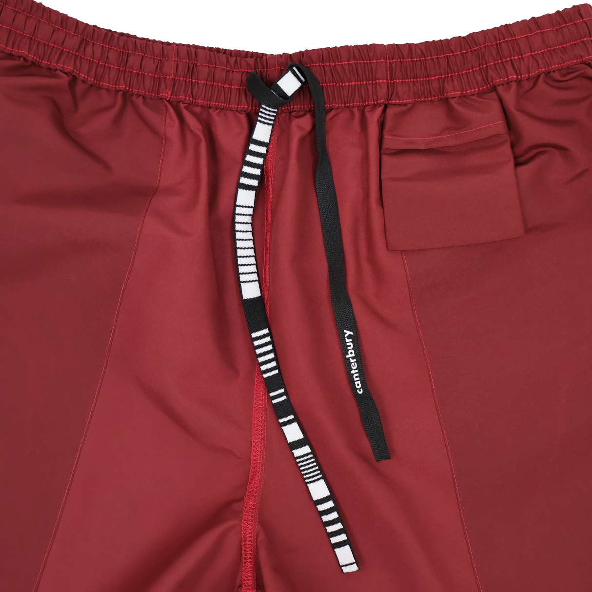 Close-up of Canterbury Uglies 5" Tactic Short in maroon, featuring an elastic waistband, small pocket, and black-and-white "Canterbury" drawstring. Durable rugby shorts designed for training performance.
