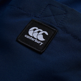 Close-up of navy blue fabric with a black and white Canterbury logo patch, highlighting the quality craftsmanship of the Women's Uglies Tactic Short by Canterbury.