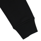 Close-up of the Canterbury Youth Uglies Logo Hoodie’s black sleeve with ribbed cuff, set against a plain white background to highlight the classic rugby-inspired style from Canterbury.