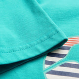 Close-up of a turquoise sleeve from the Canterbury Youth Canterbury Uglies Logo T-shirt, highlighting the fabric texture and stitching details over part of its colorful striped graphic, echoing the bold patterns distinctive to Canterbury's Uglies collection.