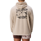Someone is seen from behind wearing the Canterbury FORCE HOODIE in beige, featuring a large abstract graphic on the back, paired with two-tone shorts.