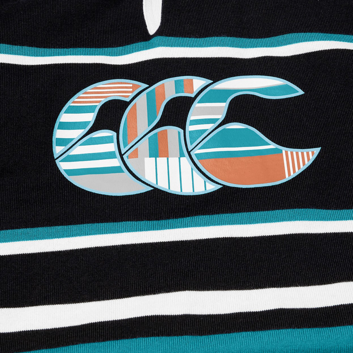 Close-up of the Canterbury Uglies Short Sleeve Classic Rugby Jersey—heavyweight cotton in black with teal, white, and orange stripes, plus a bold “CCC” logo filled with colorful patterns—a signature Canterbury look.