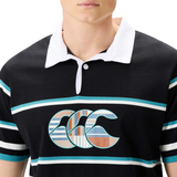 A person wearing a Canterbury Uglies Short Sleeve Classic Rugby Jersey by Canterbury, featuring black and white with teal and white horizontal stripes and a stylized logo on the chest.