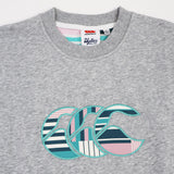Close-up of the Canterbury Women's Uglies Logo Crew Sweatshirt in grey, showcasing a large, vibrant striped and patterned CCC logo design on the front—a perfect women's rugby sweatshirt from Canterbury.