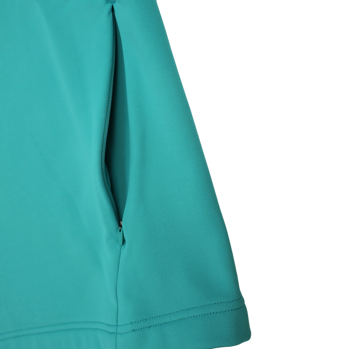 Close-up of the Ireland 26/27 Summer Tour Training Hoodie by Canterbury in teal, showcasing a zippered side pocket, precise stitching, and smooth moisture-wicking fabric.
