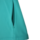 Close-up of the Ireland 26/27 Summer Tour Training Hoodie by Canterbury in teal, showcasing a zippered side pocket, precise stitching, and smooth moisture-wicking fabric.