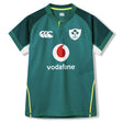 Ireland 26 Home Test Jersey by Canterbury—an authentic green short-sleeve rugby jersey featuring the Ireland badge, Vodafone sponsor logo, and distinctive white and yellow accents on the sleeves and sides.