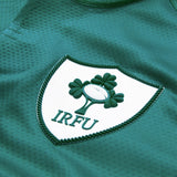 Close-up of the Ireland 26 Home Test Jersey by Canterbury, featuring the IRFU logo—a white shield with a rugby ball and shamrocks. Crafted by Canterbury, this classic green jersey offers both style and quality.