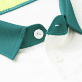 Close-up of a white collar and buttons with dark green trim and textured fabric, reminiscent of the Ireland 26 Alternate Pro Jersey by Canterbury.
