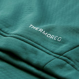 Close-up of green fabric from the Ireland 26 1/4 Zip Training Top by Canterbury, featuring the word “THERMOREG” stitched in white thread, highlighting the advanced Thermoreg technology incorporated in this Canterbury top.