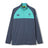 The Ireland 26 1/4 Zip Training Top by Canterbury is a long-sleeve pullover with a half-zip design, teal shoulder panels, and logo accents on a dark gray base. Featuring convenient pockets, a high collar, and advanced Thermoreg technology for warmth and comfort, this training top is designed to support your performance during every rugby session.