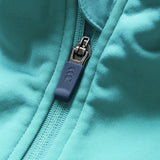 Close-up of the Ireland 26 1/4 Zip Training Top by Canterbury in teal fabric, inspired by Ireland rugby, featuring a prominent blue zipper and pull tab in a partially zipped position.