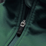 Close-up of the Ireland 26 1/4 Zip Training Top by Canterbury, showcasing a dark green design with a partially zipped silver zipper and a black fabric pull tab, styled in Canterbury’s signature 1/4 zip fashion.
