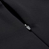Close-up of a partially unzipped black fabric zipper on the Ireland 26 1/4 Zip Training Top by Canterbury, highlighting the metal zipper pull and textured material, enhanced with Thermoreg technology.