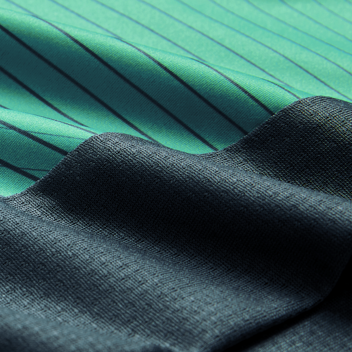 Close-up of two fabrics: one green with thin black stripes, inspired by the Canterbury Ireland 26/27 Summer Tour Superlight Training Tank, and one textured dark blue. The fabrics overlap diagonally.