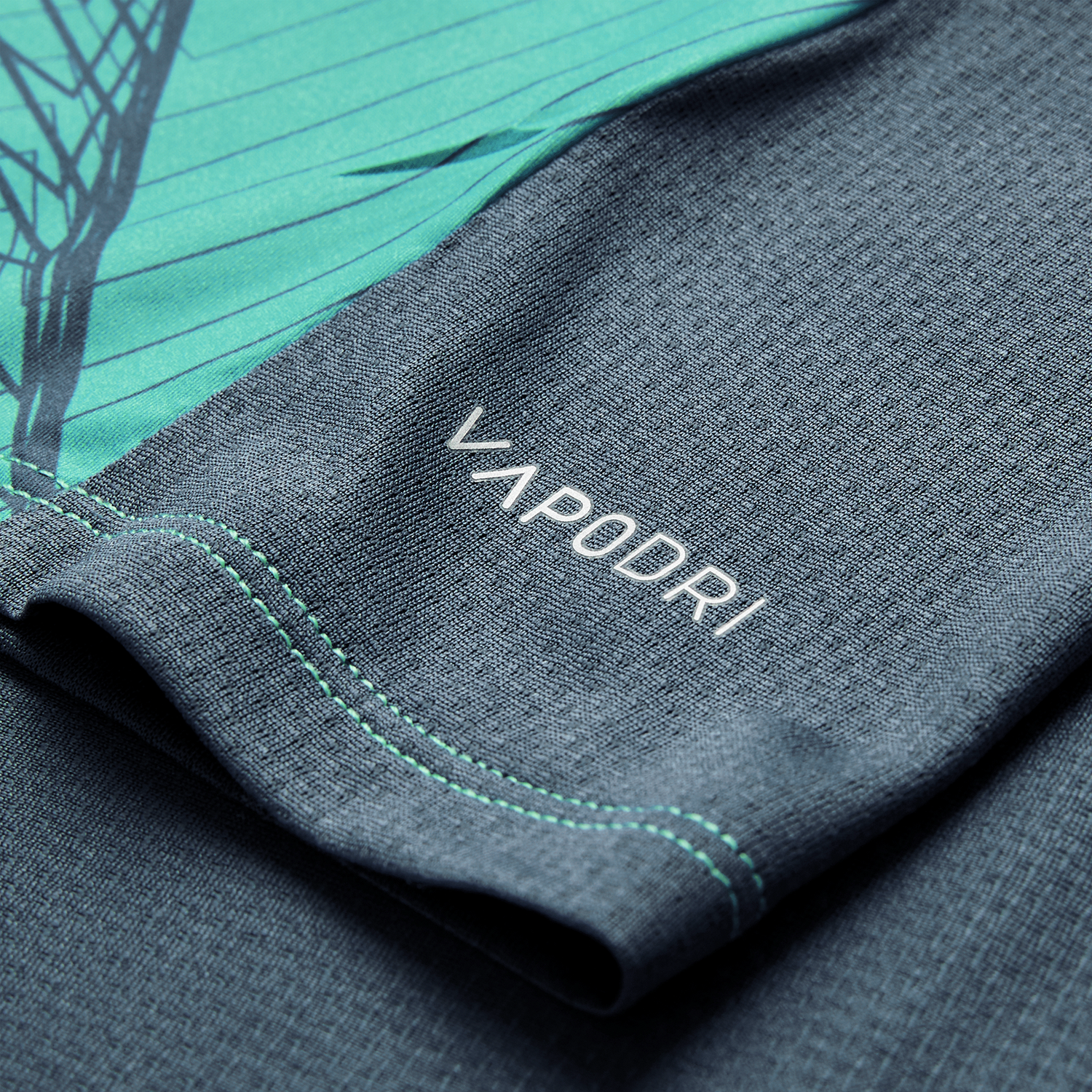 Close-up of the textured gray and teal fabric from the Canterbury Ireland 26/27 Summer Tour Superlight Training Tank, featuring "VAPODRI" in white lettering.