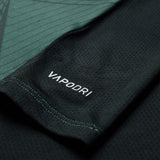 Close-up of a black athletic shirt sleeve from the Canterbury Ireland 26 Training Tank, featuring “VAPODRI” printed in white and a subtle green geometric pattern inspired by the latest Canterbury design.