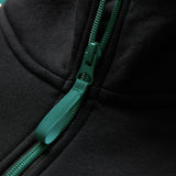 Close-up of a green zipper with a matching fabric pull tab on the Canterbury Women’s Ireland 26 Legends 1/4 Zip Sweatshirt, inspired by the classic Ireland Rugby sweatshirt.