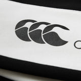 Close-up of a black and white striped fabric featuring the Canterbury logo with three overlapping stylized C’s, as seen on the Women’s Ireland 26 Legends Fleece Pant by Canterbury, echoing the iconic detailing found in classic Canterbury pant collections.