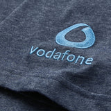 Close-up of a blue fabric with an embroidered Vodafone logo and text in light blue thread, featured on the official Canterbury Women’s Ireland 26 Cotton T-shirt.