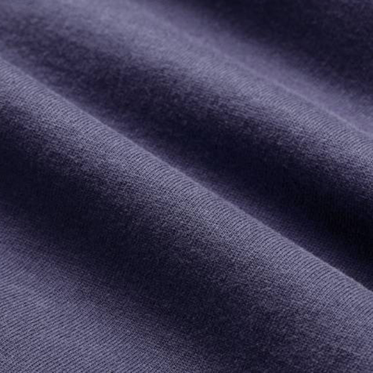 Close-up of a purple fabric with a soft, smooth texture and visible horizontal folds, reflecting the premium quality of the Women’s Ireland 26 Cotton T-shirt by Canterbury.