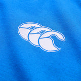 Close-up of the Canterbury Tempo+ GFX Training Tank in blue, showcasing a white Canterbury logo with three overlapping stylized “C” shapes—ideal for training sessions or as a lightweight workout tank.