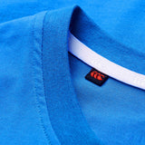 Close-up of a blue Canterbury Tempo+ GFX Training Tank collar featuring a white inner seam and a visible black and red Canterbury brand tag stitched inside the neckline, showcasing classic training wear inspired detailing.