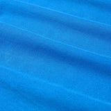 Close-up of blue fabric with horizontal folds and a soft texture, highlighting the premium quality of the Canterbury Tempo+ GFX Training Tank by Canterbury.