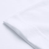Close-up of the sleeve and seam of a Canterbury Tempo+ GFX Training T-Shirt in plain white, laid flat on a white surface.