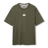 The Canterbury Tempo+ GFX Training T-Shirt in olive green features short sleeves and a small white Canterbury logo on the chest, shown against a white background. This lightweight gym shirt is ideal for everyday wear or as a dependable rugby training t-shirt.