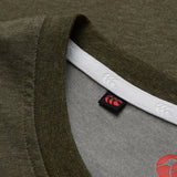 Close-up of the collar on a Canterbury Tempo+ GFX Training T-Shirt in olive green, featuring a white inner lining and a small black tag with the Canterbury red and white logo.