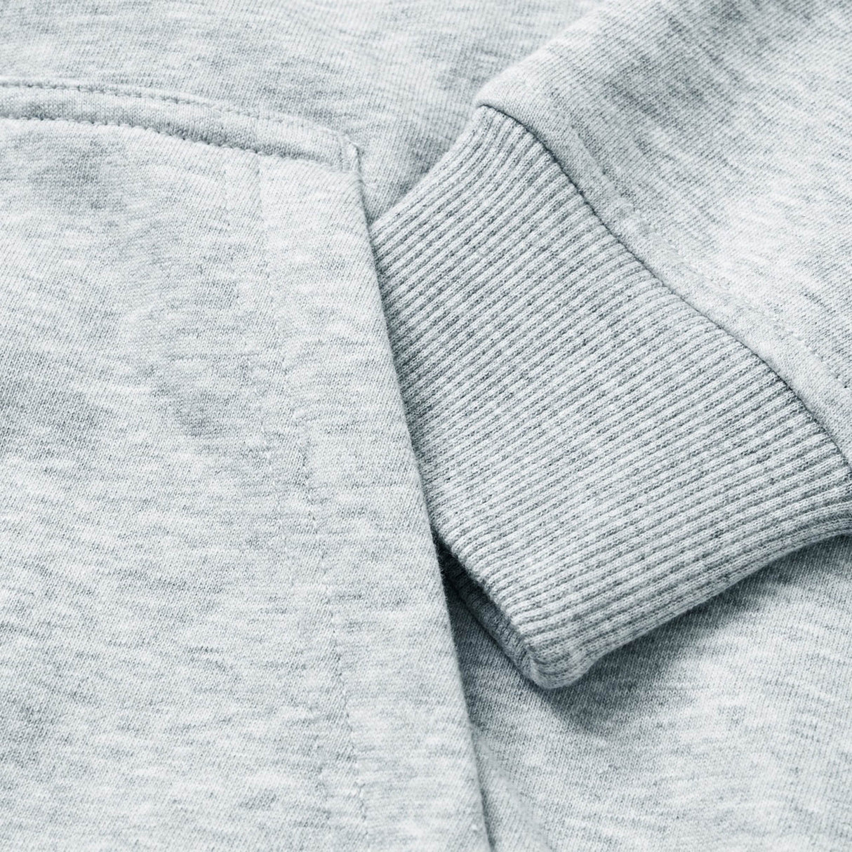 Close-up of the sleeve on the light gray Canterbury Women Rakaia 2.0 Hoodie, featuring a ribbed cuff resting over the matching sweatshirt body.