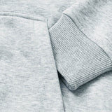 Close-up of the sleeve on the light gray Canterbury Women Rakaia 2.0 Hoodie, featuring a ribbed cuff resting over the matching sweatshirt body.