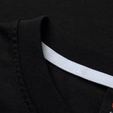 Close-up of the Canterbury Rakaia 2.0 T-shirt in black, featuring a detailed view of the collar with its white interior neckline strip, embossed pattern, and visible stitching—showcasing Canterbury’s renowned craftsmanship in New Zealand rugby apparel.
