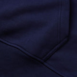 Close-up of the Canterbury Rakaia 2.0 Hoodie in dark blue, featuring visible stitching and seam details characteristic of Canterbury garments.