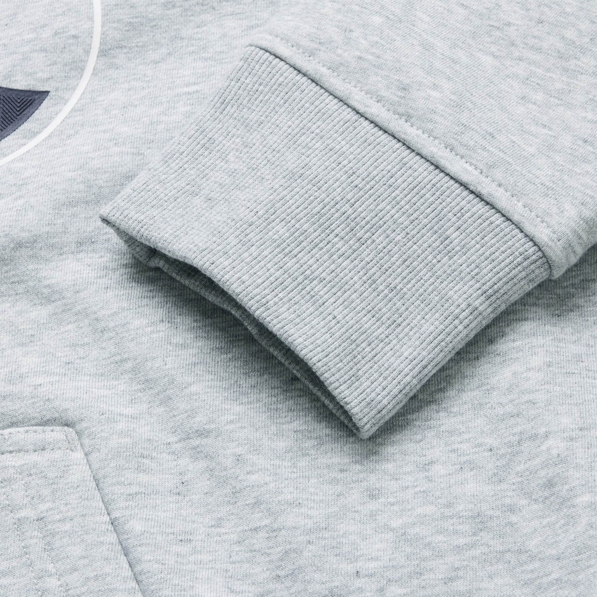 Close-up of the cuff and pocket on the light gray Canterbury Rakaia 2.0 Hoodie, highlighting the ribbed texture of the sleeve and the smooth fabric of the body.