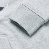 Close-up of the cuff and pocket on the light gray Canterbury Rakaia 2.0 Hoodie, highlighting the ribbed texture of the sleeve and the smooth fabric of the body.