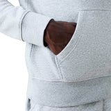 A person wearing a light gray Canterbury Rakaia 2.0 Hoodie with their right hand in the front pocket, against a plain white background.